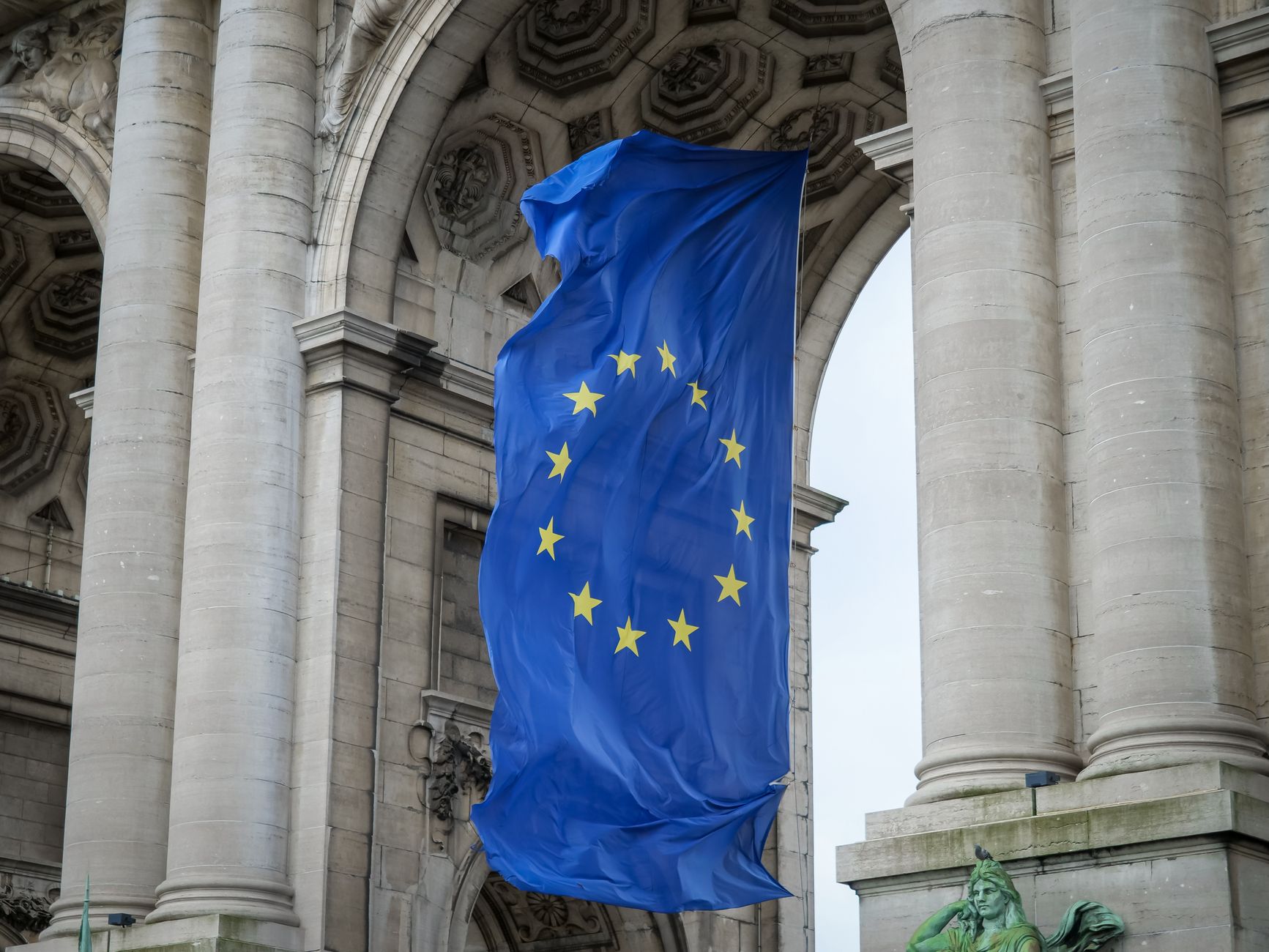 The European Union flag flying in Brussels — the jurisdiction behind the world's most-copied privacy law.