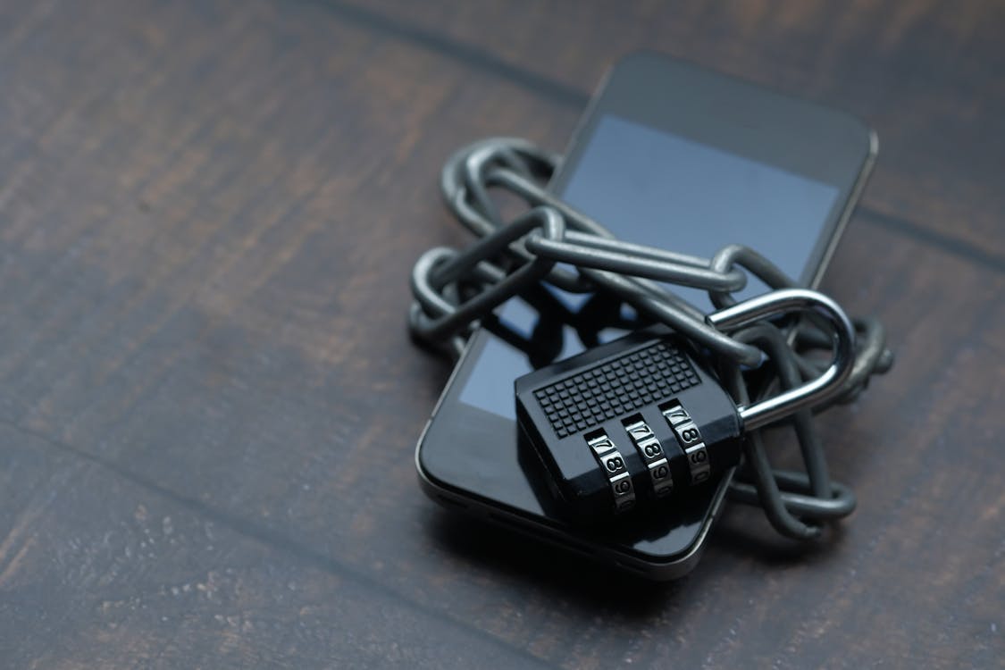 Phone wrapped in a chain and padlock — representing GDPR data protection obligations.