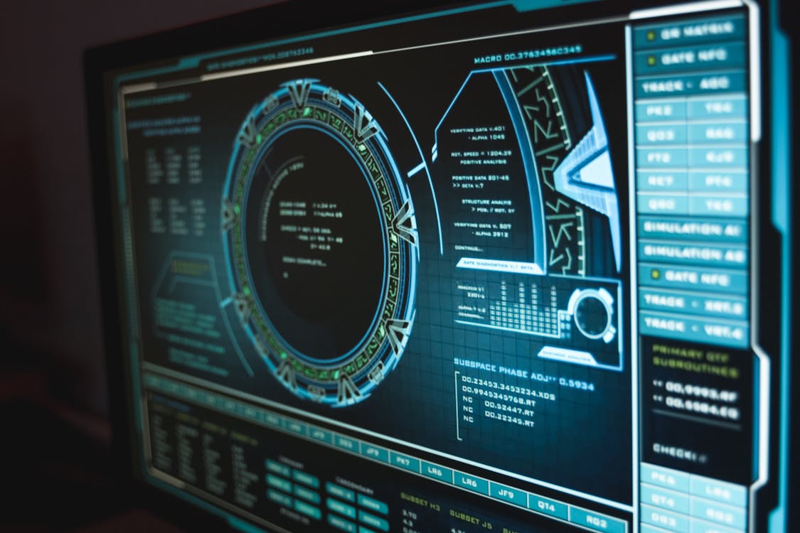 Dark monitor with a teal futuristic HUD interface — representing HIPAA security safeguards.